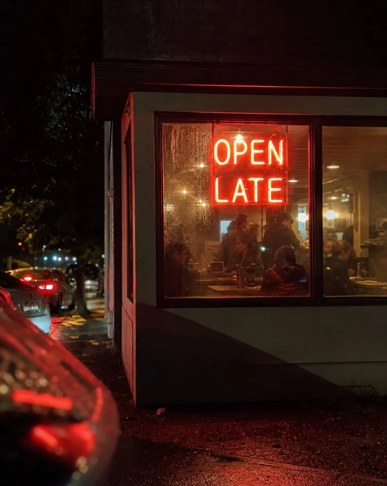 The front window on Cotham Hill lit from inside at dusk